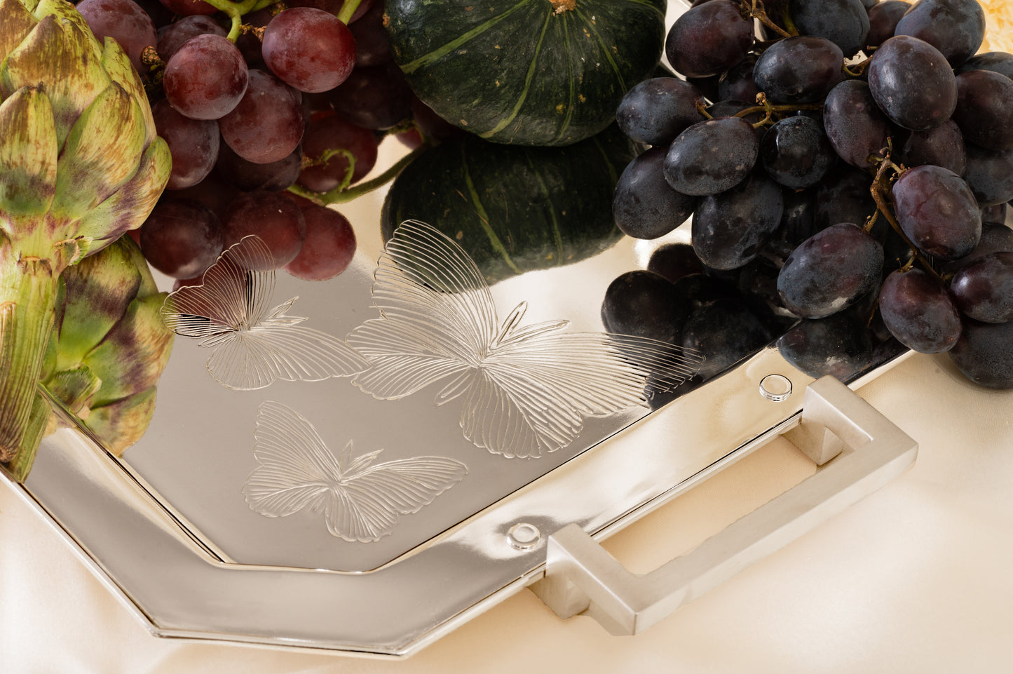 Silverstein Butterfly Serving Tray elegantly styled with grapes and refreshments for luxury table serving.