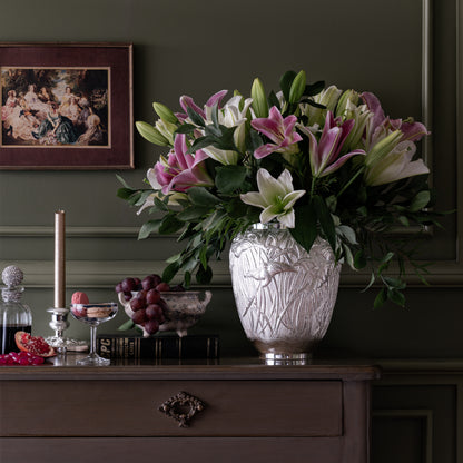 Luxury Silver Plated Birds of Paradise Vase featuring handcrafted bird and leaf detailing, beautifully displayed with fresh flowers in an elegant home décor setting by Silverstein.